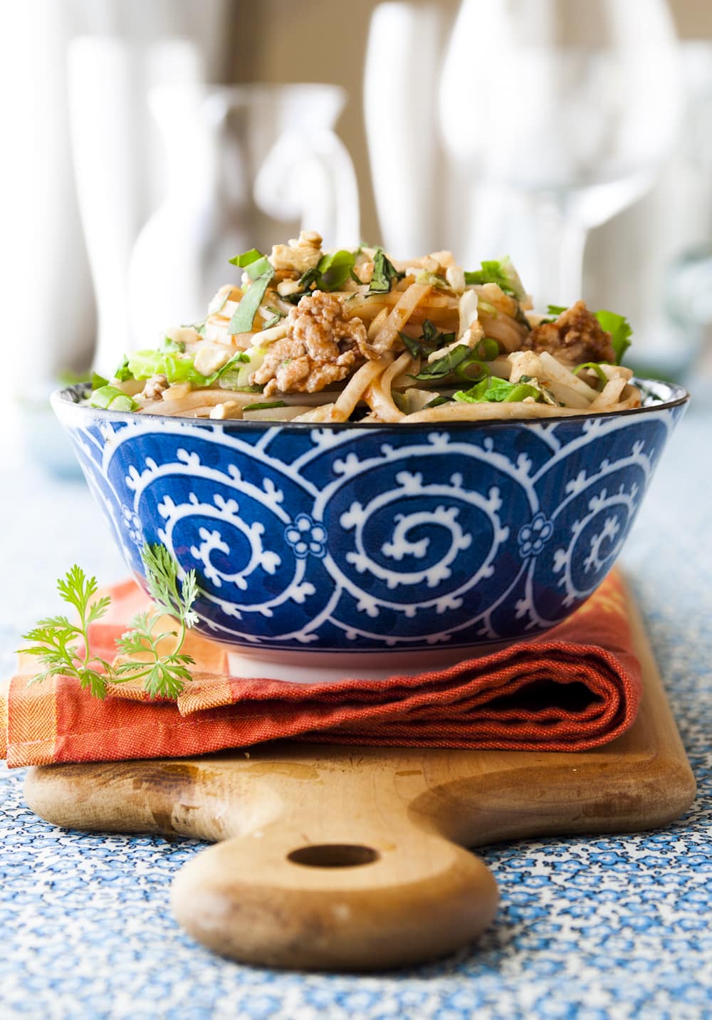 a blue and white bowl of pad thai