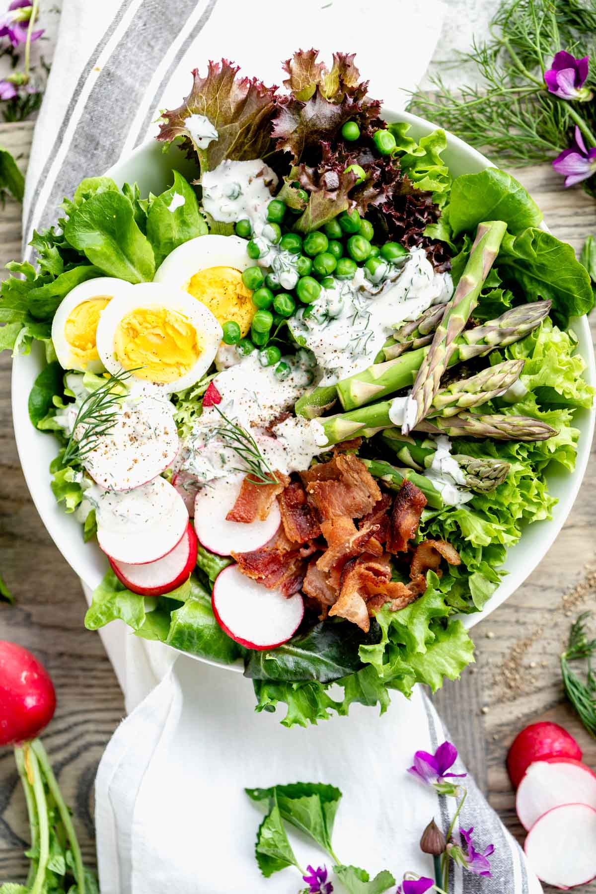 overhead of composed salad with dressing on it