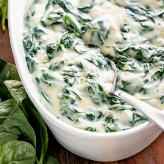 close-up of creamed spinach with cheese in serving platter
