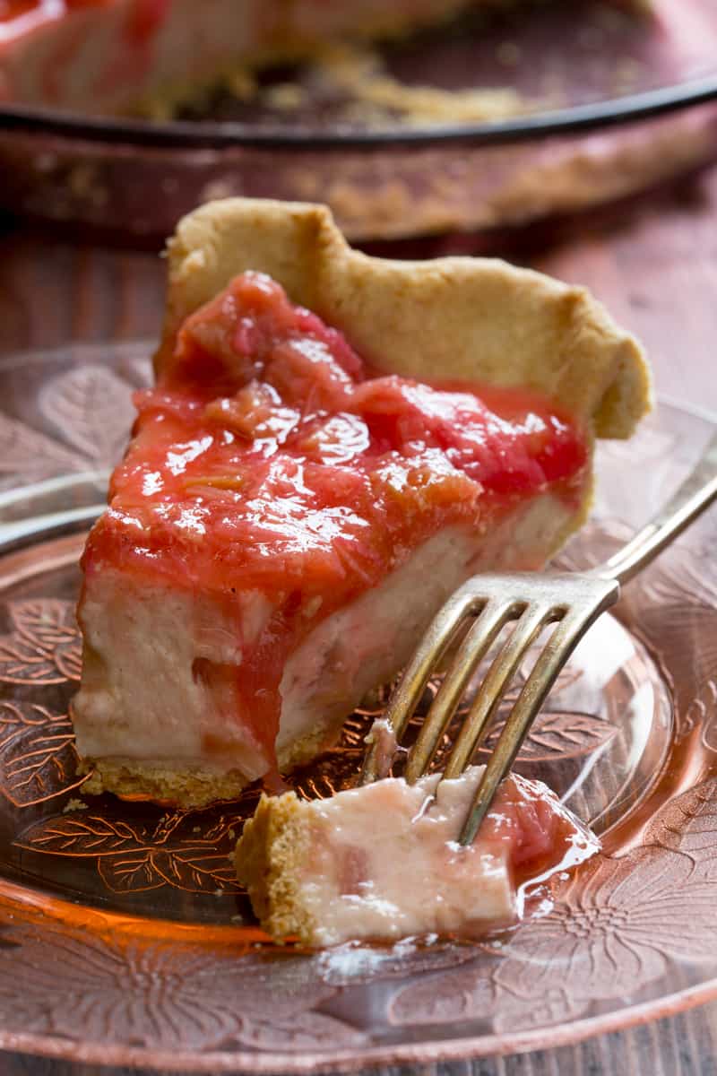 A slice of Light Rhubarb Pie on a plate with a fork 