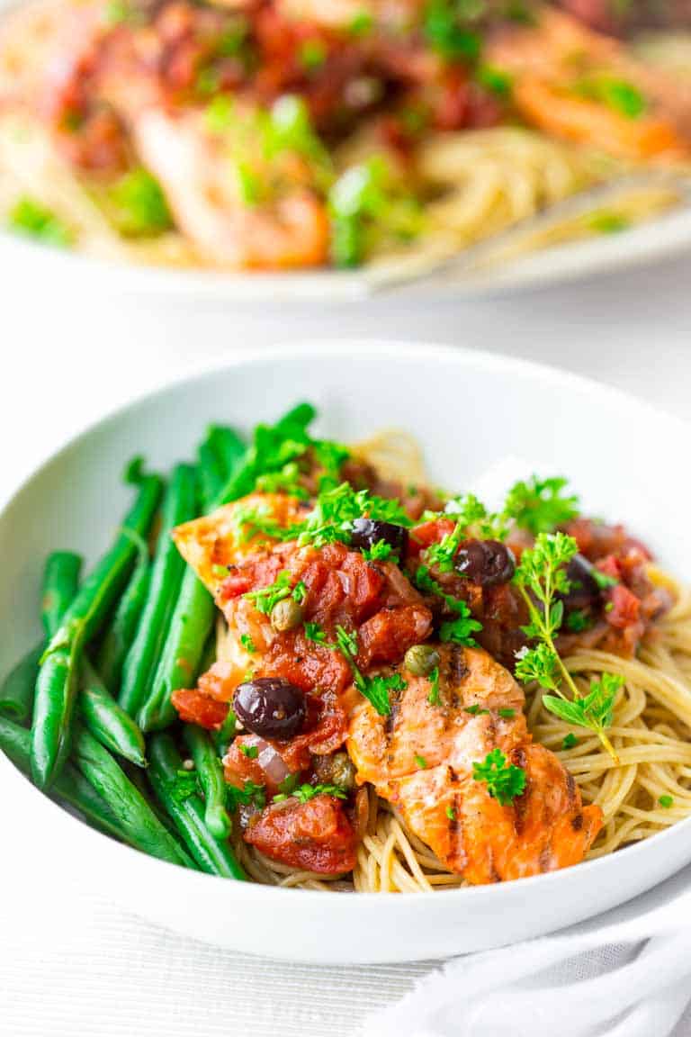 Healthy Grilled Salmon Puttanesca with Garlic tomato sauce with olives and capers. @healthyseasonal
