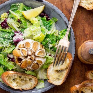 Garlic Lover's Roasted Garlic Caesar Salad, with roasted garlic in the dressing and a whole head of roasted garlic to go on each serving! The dressing is egg-free and it has capers in it!! | Healthy Seasonal Recipes | Katie Webster