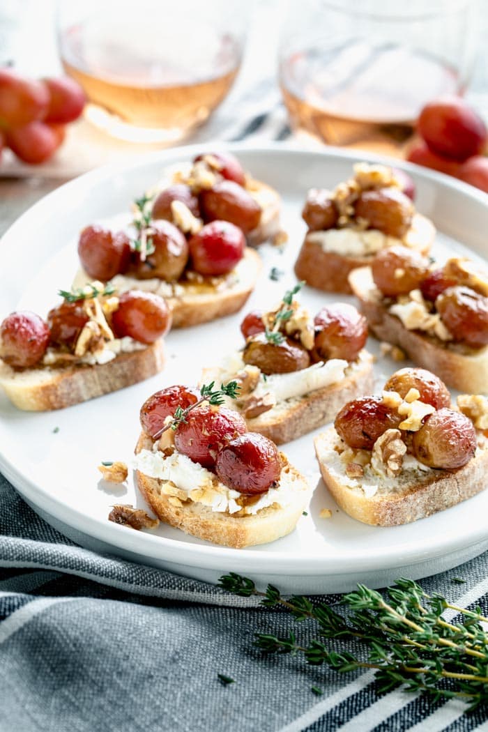 a platter of crostini from the side with a gray napkin