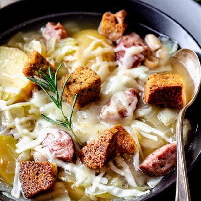 kielbasa and cabbage soup in black bowl