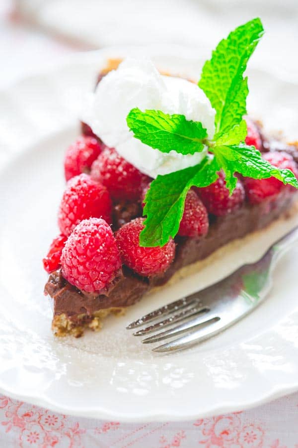 a slice of Healthy Raspberry Tart Recipe with Chocolate on a plate
