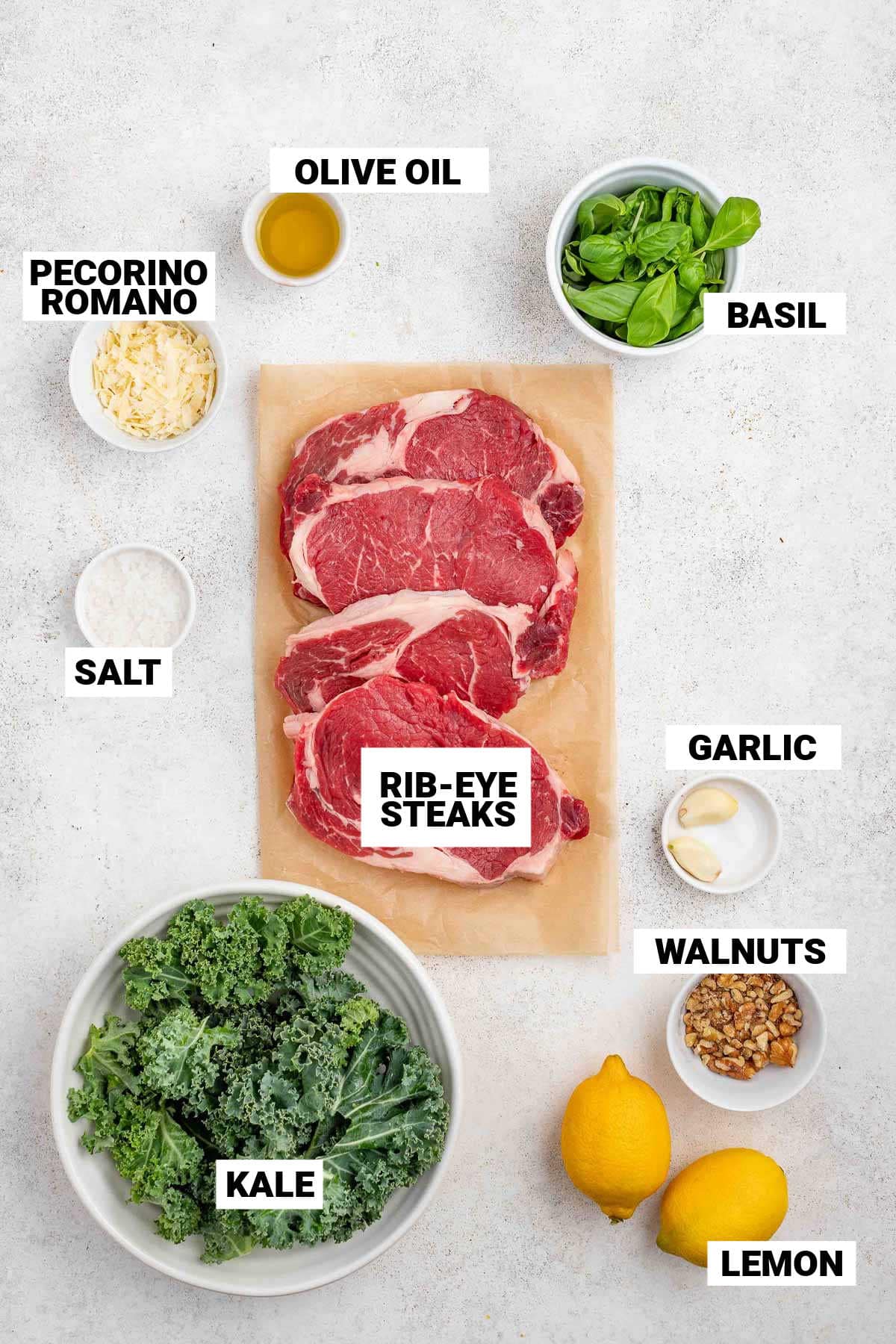 the steak and ingredients for the pesto on a white surface with text overlay