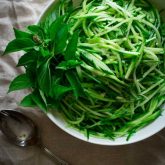 cucumber noodles in a white bowl on a napkin