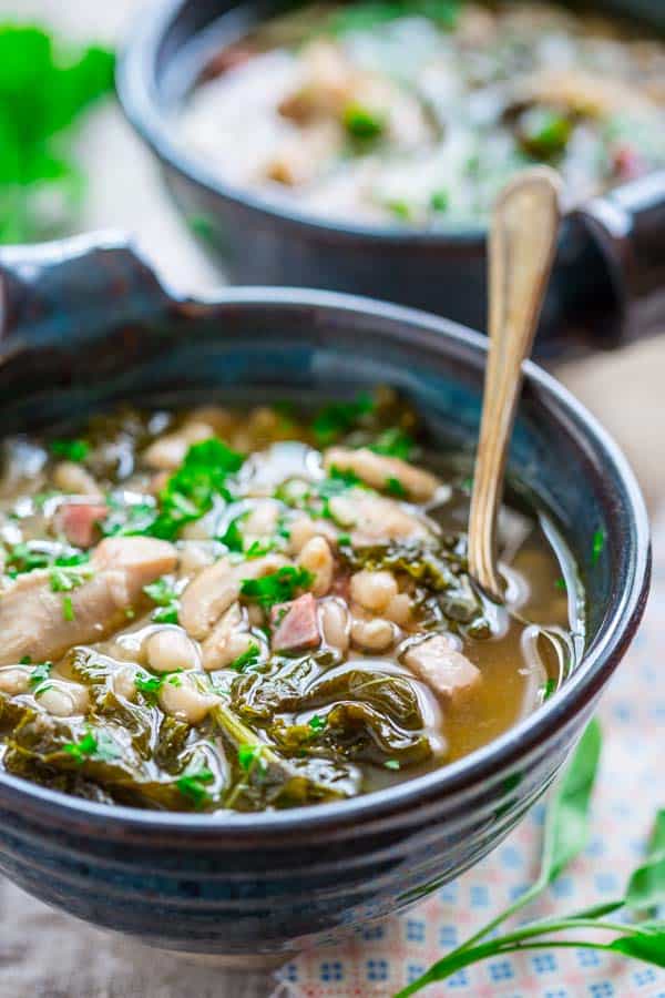 Slow Cooker White Bean Stew with Chicken and Ham in a serving bowl with a spoon