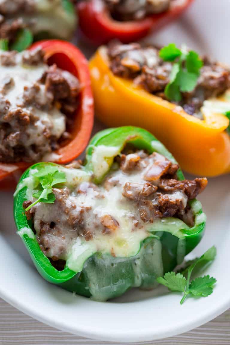 a close up of mexican stuffed peppers with lots of melted cheese