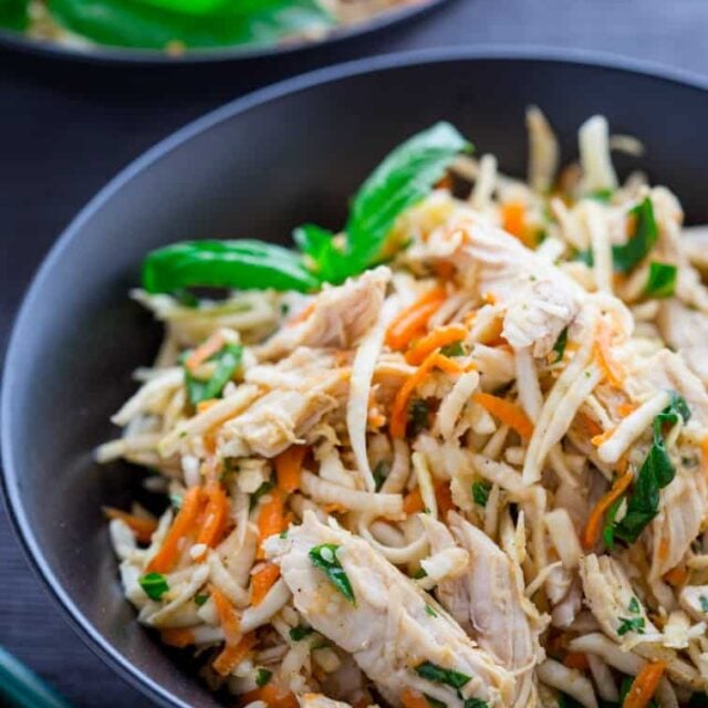 black bowl with the shredded celery root salad with chicken and carrots