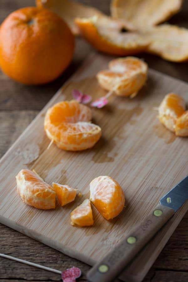 cutting mandorines for heart-shaped decorations on Valentine's Day by Katie Webster on HealthySeasonalRecipes.com