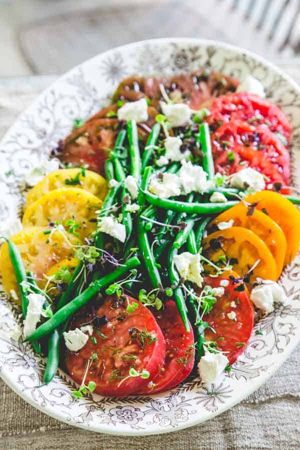 Tomato and Green Bean Salad with goat cheese on a serving platter 