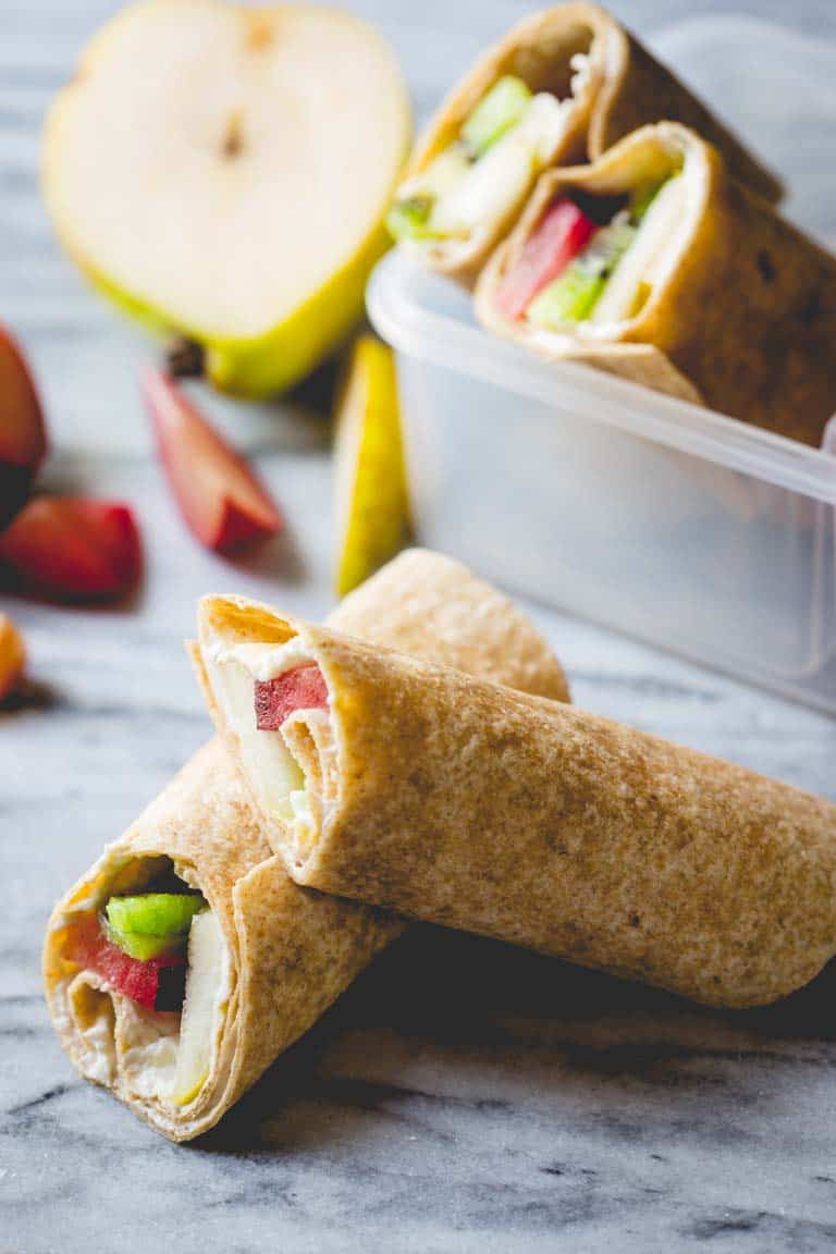 Fruit and Cream Cheese Lunch Wraps on counter with fruit 