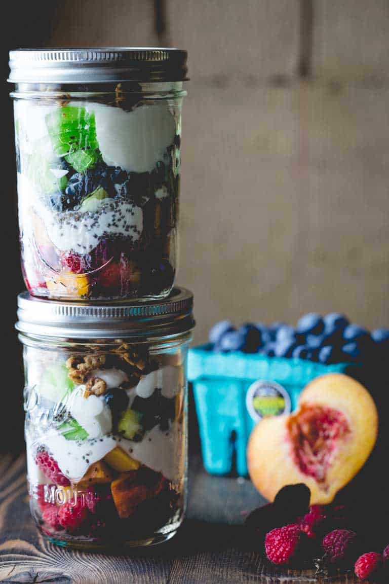 Fruit and Granola Parfait jars stacked on top of each other 