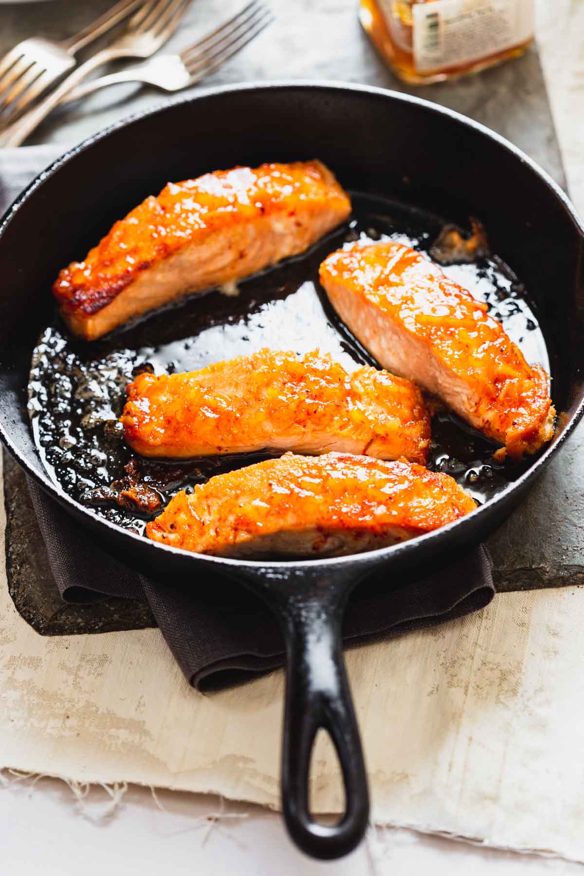 salmon in a skillet with glaze with backlight