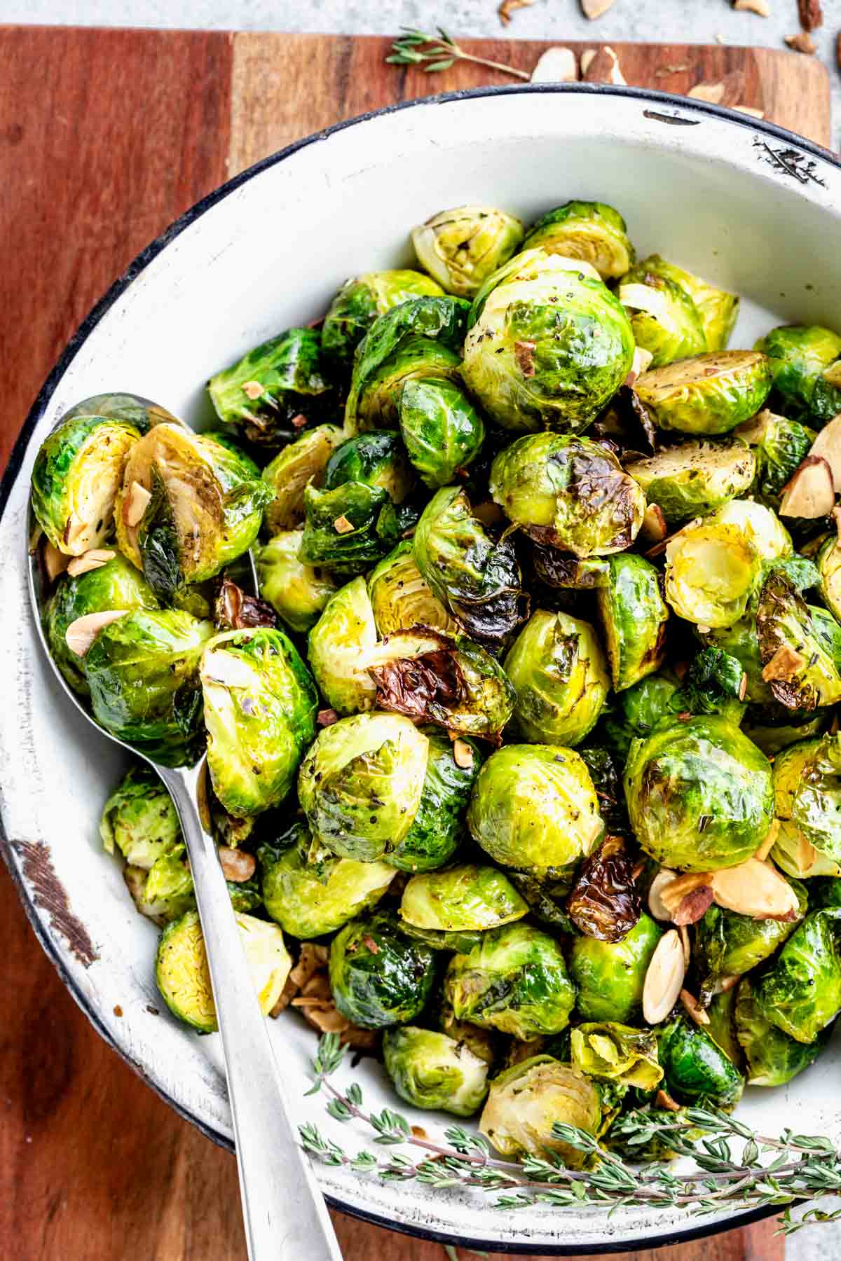 a white dish with brussels sprouts in it