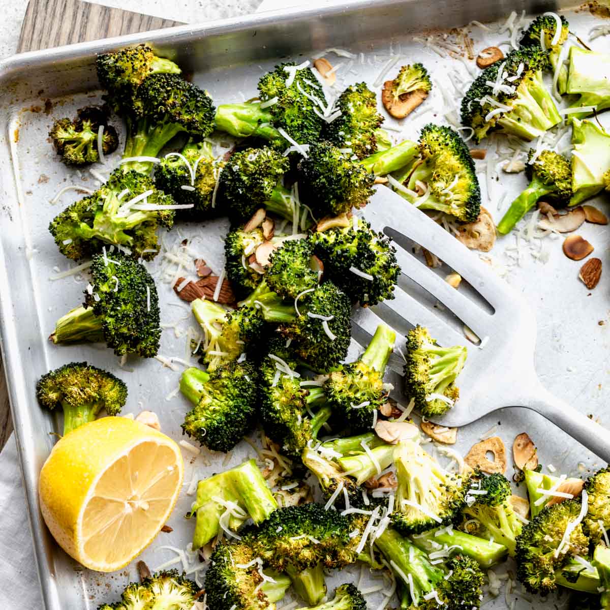 close up view of roasted broccoli on sheet pan