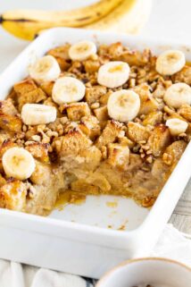 bread pudding in a casserole dish with a serving removed