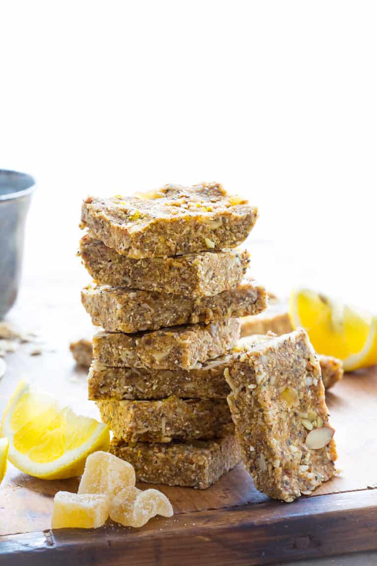 Lemon, almonds, chia and crystallized ginger no-bake bars stacked on top of each other 