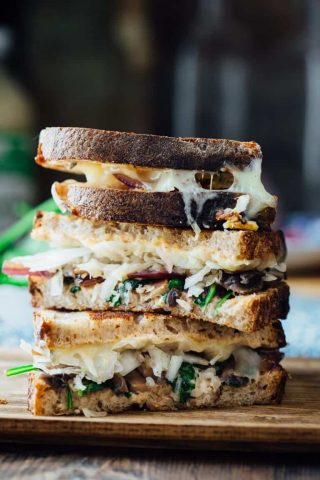 This Skinny Vegetable Reuben is loaded with sautéed mushrooms, onions and spinach, topped with lacto-fermented sauerkraut and sauced with home-made skinny Russian dressing. It is ready in less than 30 minutes for an awesome vegetarian meal the whole family will love! | Healthy Seasonal Recipes | Katie Webster