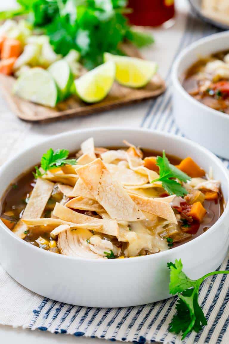 Slow cooker Chicken Tortilla Soup in white bowl