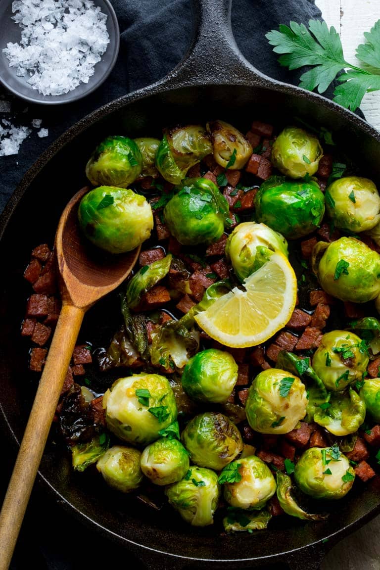 Brussels Sprouts in a skillet with a serving spoon 
