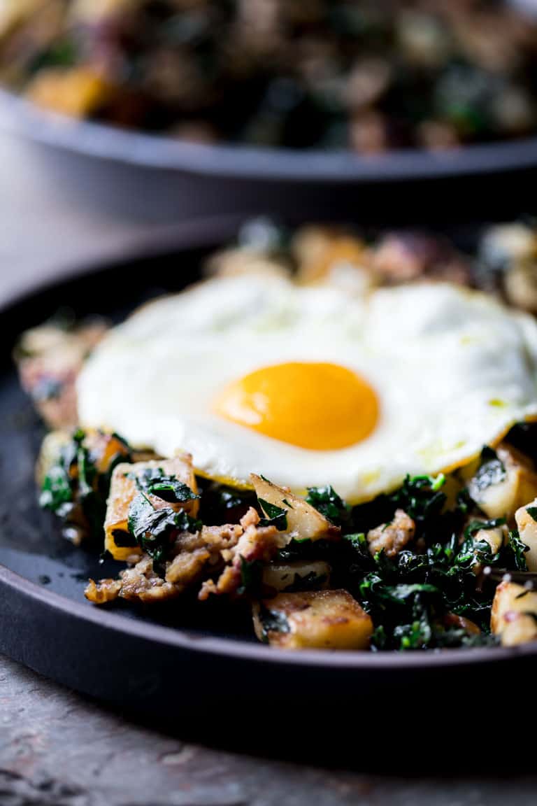 A close up shot of Sausage Breakfast Hash with a fried sunny side up egg