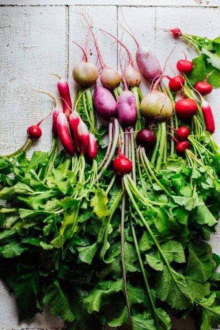 The Ultimate Guide to Radishes, part of my Produce Spotlight Series on Healthy Seasonal Recipes. Your questions about if it okay to eat radishes on the keto diet. Can I cook radishes and can you eat radish greens. By Katie Webster. #radishes