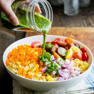 Get read to fall in love with this vegan Corn Salad with Jalapeno and Cilantro Dressing with cherry tomatoes, red onion and bell pepper. It will totally put you in the mood for easy summer evenings. #vegan #cornsalad #corn #sidedish #summer #easy #picnic #barbecue #20minuterecipe