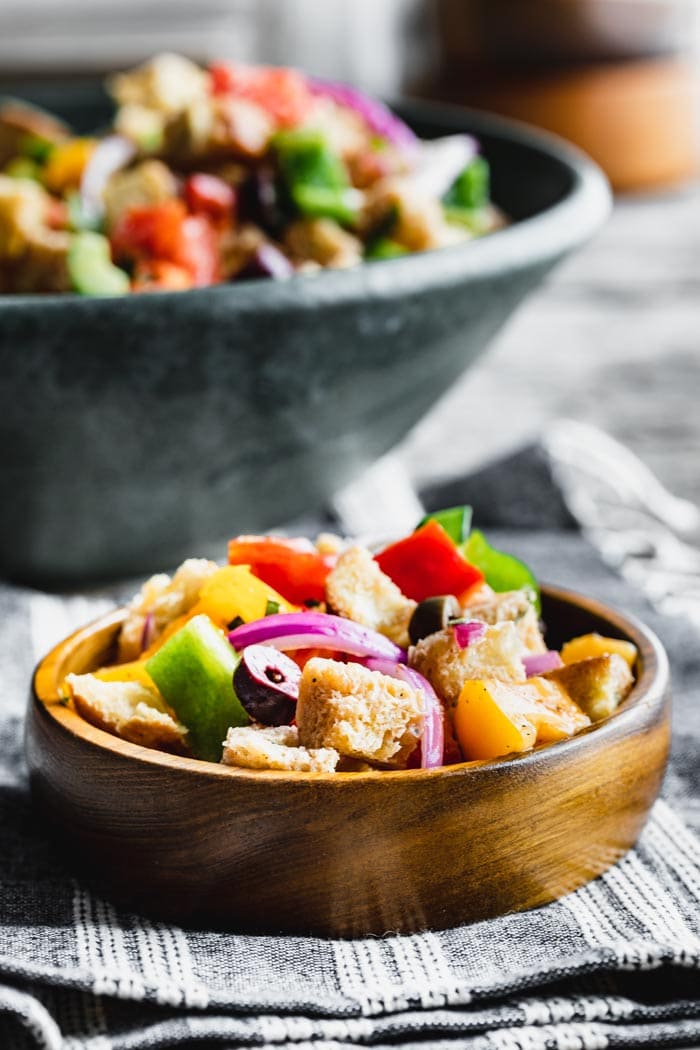 side view of panzanella in a wooden bowl