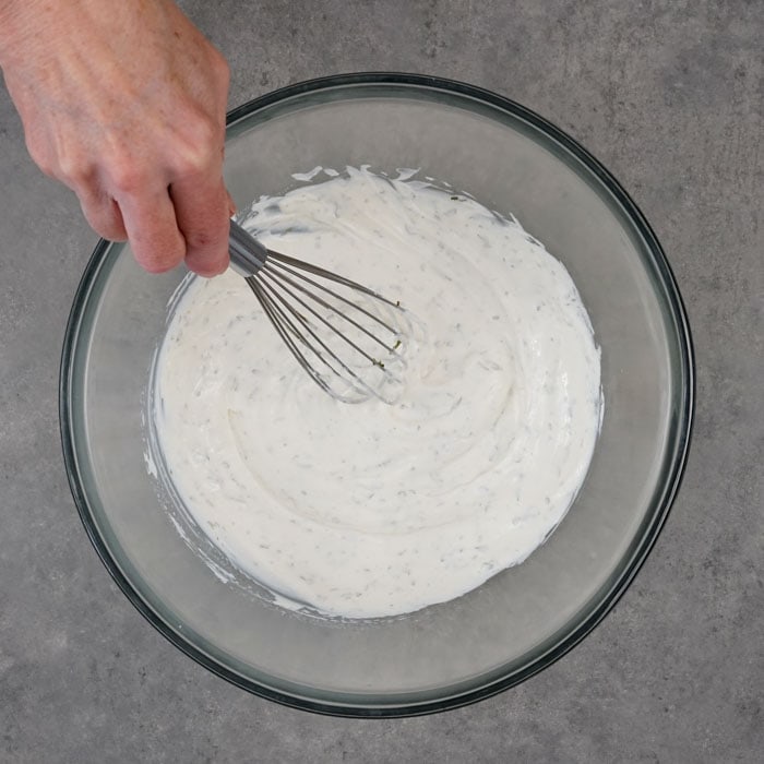 Whisk the dressing in a large bowl.