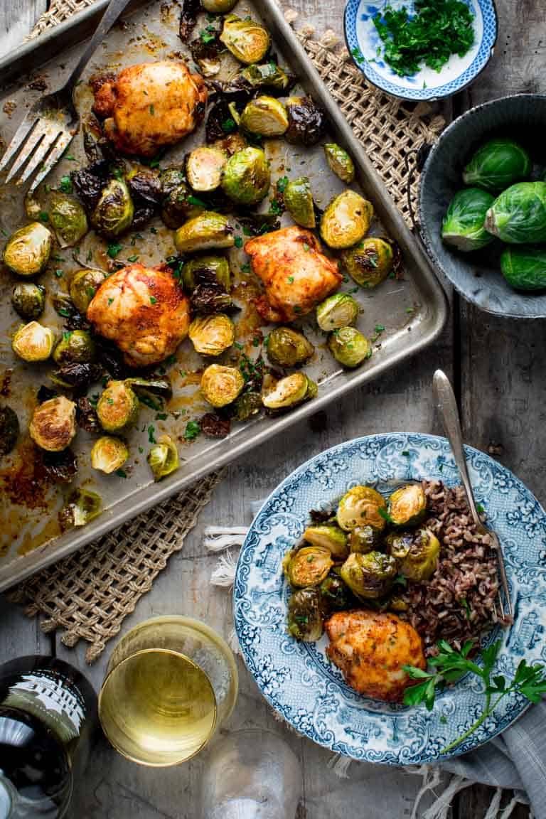 Chicken and Brussels Sprouts Sheet Pan DInner on a sheet pan and also on a plate from overhead