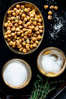 bowl of crispy roasted chickpeas with 2 glasses of beer and salt