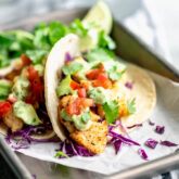 two cod fish tacos on a plate