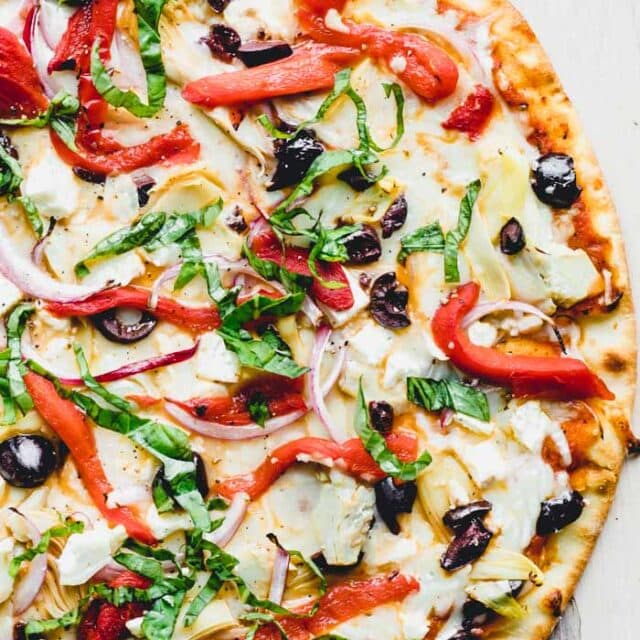 A pizza sitting on top of a cutting board