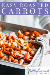 holding sheet pan of carrots