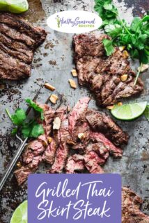 skirt steak on a baking sheet cut into slices and a lime wedge