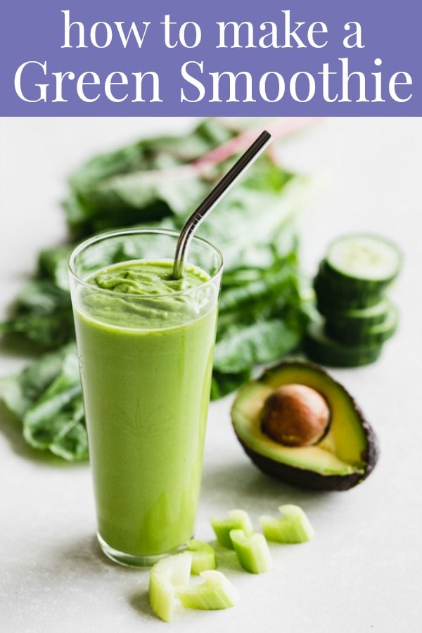 Green smoothie surrounded by ingredients
