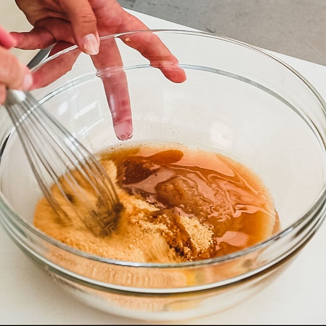 Whisking egg, applesauce, the remaining 1 cup plus 2 tablespoons sugar and oil in a medium bowl
