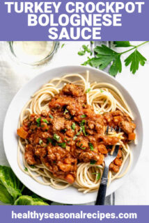 a serving of bolognese sauce over pasta in a white bowl