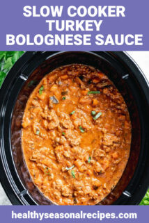 a black crock، with bolognese sauce in it