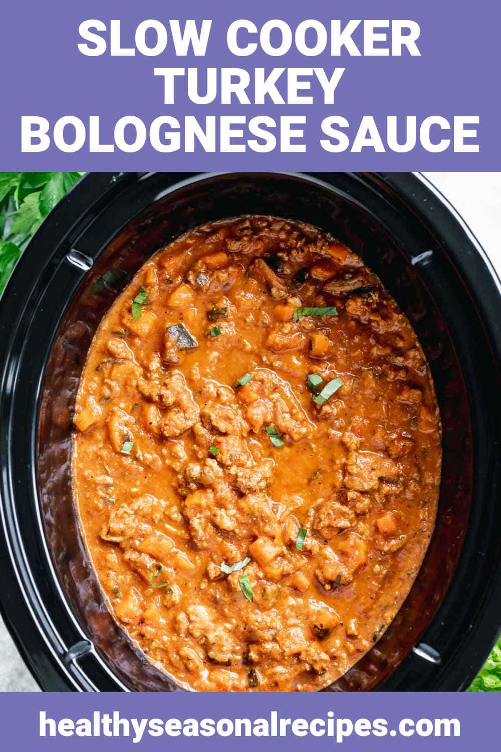 a black crockpot with bolognese sauce in it