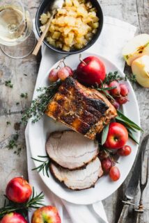 Roasted Pork Loin with apples and herbs on an oval platter from overhead