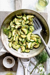 a skillet with sauteed zucchini in it