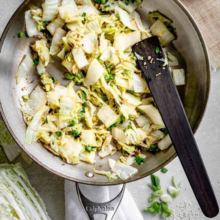 a skillet with the sauteed Napa cabbage in it