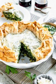 spinach feta filo pie with one slice missing