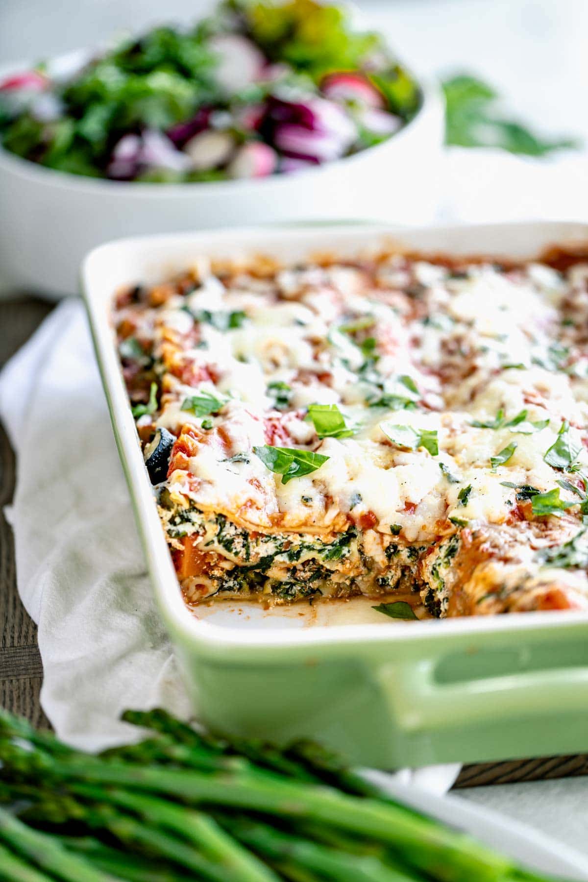 Easy vegetable lasagna in baking dish with slice missing. 