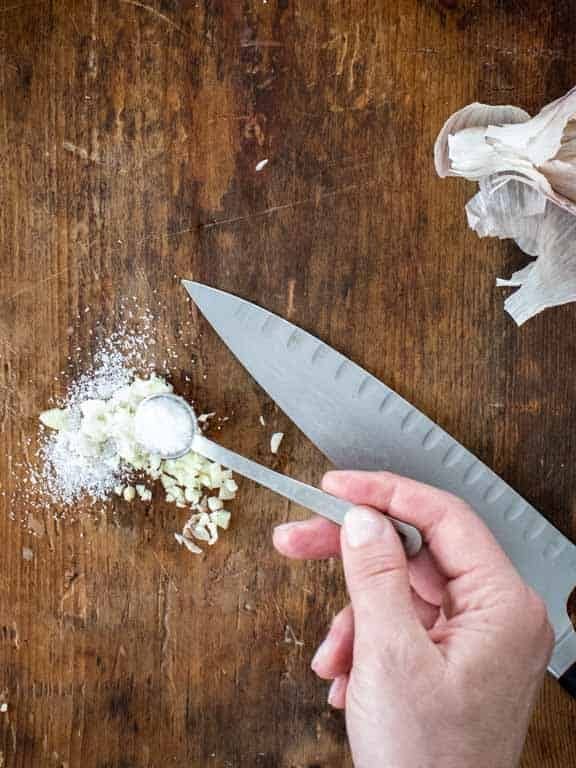 chop the garlic then sprinkle with salt