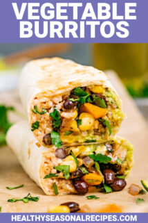 two halved vegetable burritos stacked on top of each other so you can see the beans, brown rice, corn, bell peppers, and more inside