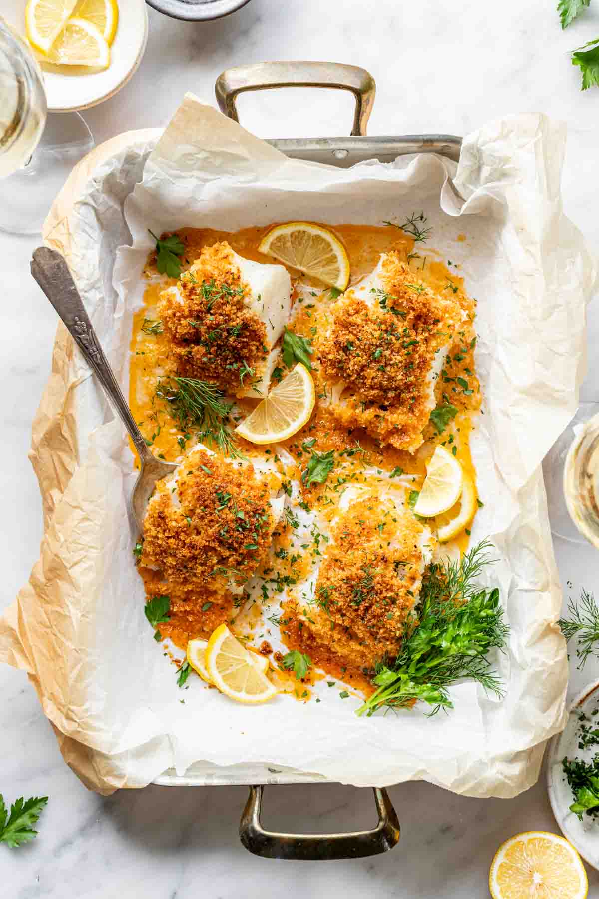 overhead p،to of baked cod with panko in a rectangular baking dish